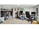 Functional basement space featuring a gaming setup, closet filled with clothes, and a cozy carpeted floor at 6106 Evanston Ave, Indianapolis, IN 46220