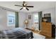 Spacious bedroom with hardwood floors, natural light, and a ceiling fan at 6106 Evanston Ave, Indianapolis, IN 46220