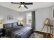 Comfortable bedroom featuring a ceiling fan, artwork, and natural light at 6106 Evanston Ave, Indianapolis, IN 46220