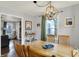 Open dining space with hardwood floors, a wooden table, and a view into the living area at 6106 Evanston Ave, Indianapolis, IN 46220