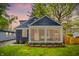 Charming home with a screened porch, blue siding, and well-maintained landscaping at 6106 Evanston Ave, Indianapolis, IN 46220