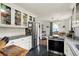 Well-lit kitchen featuring stainless steel appliances, white cabinetry, and a breakfast area at 6106 Evanston Ave, Indianapolis, IN 46220