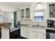 Updated kitchen showcasing stainless steel appliances, granite countertops, and white cabinetry at 6106 Evanston Ave, Indianapolis, IN 46220