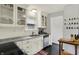 Charming kitchen with white cabinetry, modern appliances, granite countertops, and tile backsplash at 6106 Evanston Ave, Indianapolis, IN 46220