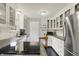 Bright kitchen featuring white cabinets, modern appliances, and sleek countertops at 6106 Evanston Ave, Indianapolis, IN 46220