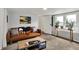 Inviting living space with a plush brown sofa, stylish pillows, coffee table, and natural light from the window at 6106 Evanston Ave, Indianapolis, IN 46220
