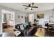 Cozy living room with a comfortable sofa, hardwood floors, and an adjacent dining and kitchen area at 6106 Evanston Ave, Indianapolis, IN 46220