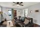 Comfortable living room with hardwood floors, a large sofa, and natural light from the windows at 6106 Evanston Ave, Indianapolis, IN 46220
