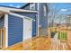 Spacious wooden deck on a blue house, with a wooden fence and a clear path leading to the backyard at 614 Park Ave, Anderson, IN 46012
