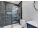 Renovated bathroom features a glass shower with black tile and sleek fixtures at 614 Park Ave, Anderson, IN 46012