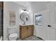 Bathroom featuring patterned floor tiles, a wood vanity, modern fixtures, and bright natural light at 614 Park Ave, Anderson, IN 46012