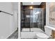 Bright bathroom featuring stylish black shower tiles, patterned floor tiles, and a modern design at 614 Park Ave, Anderson, IN 46012