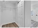 Walk-in closet with shelving, next to a sliding door and stylish patterned tile entryway flooring at 614 Park Ave, Anderson, IN 46012