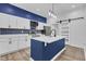 The open kitchen features stainless appliances, white cabinetry, and a large island at 614 Park Ave, Anderson, IN 46012