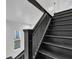 Black painted stairs lead to the upper level of the home at 614 Park Ave, Anderson, IN 46012
