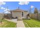 Well-maintained backyard with a patio, seating, grill, a grassy area, and partial fence at 6194 Evanston Ave, Indianapolis, IN 46220