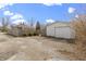 The backyard features a detached garage with a long driveway and tall privacy fence at 6194 Evanston Ave, Indianapolis, IN 46220