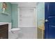 Charming bathroom featuring a shower-tub combo, white subway tile, and built-in shelving for storage at 6194 Evanston Ave, Indianapolis, IN 46220