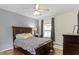 Cozy bedroom with neutral color scheme, ceiling fan, and wood-look floors at 6194 Evanston Ave, Indianapolis, IN 46220