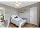 This cozy bedroom has wood floors and neutral walls at 6194 Evanston Ave, Indianapolis, IN 46220