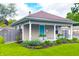 Charming home with a welcoming porch, beautiful landscaping, and a bright blue front door at 6194 Evanston Ave, Indianapolis, IN 46220