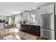 Kitchen open to dining area features stainless steel appliances and white subway tile backsplash at 6194 Evanston Ave, Indianapolis, IN 46220