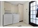Bright laundry room with tile floors, full size washer and dryer, and plenty of cabinet space at 6194 Evanston Ave, Indianapolis, IN 46220