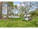 Large backyard features a playset and backs up to a lake at 693 Prince Dr, Greenwood, IN 46142