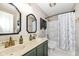 This bathroom has double sinks with vintage fixtures, a vanity, and a tub with a shower at 693 Prince Dr, Greenwood, IN 46142