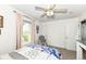 This quaint bedroom has a ceiling fan, pink curtains, a glider chair, and a neutral color scheme at 693 Prince Dr, Greenwood, IN 46142