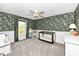 This carpeted Bedroom has dark, floral wallpaper, a black crib, and a charming glider chair at 693 Prince Dr, Greenwood, IN 46142