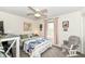 This quaint bedroom features a ceiling fan, a glider chair, and a view to the outdoors at 693 Prince Dr, Greenwood, IN 46142