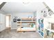 This carpeted bedroom features built-in bunkbeds, shelving, and neutral paint at 693 Prince Dr, Greenwood, IN 46142