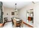 Formal dining room featuring a modern chandelier, wainscoting, and hardwood floors at 693 Prince Dr, Greenwood, IN 46142