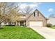 Charming two-story home featuring a brick facade, well-maintained lawn, and attached two-car garage at 693 Prince Dr, Greenwood, IN 46142