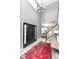 Grand foyer showcasing a soaring ceiling, modern chandelier, and staircase with black and white accents at 693 Prince Dr, Greenwood, IN 46142
