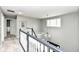 Upstairs hallway featuring neutral paint, gray carpet, window, and chandelier at 693 Prince Dr, Greenwood, IN 46142