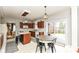 Eat-in kitchen features stainless appliances, wood cabinets, and sliding glass doors to backyard patio at 693 Prince Dr, Greenwood, IN 46142