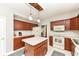 Well-lit kitchen featuring cherry cabinets, a center island, and modern appliances at 693 Prince Dr, Greenwood, IN 46142