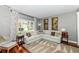 This bright living room features a large window, wood floors, comfortable seating, and neutral paint at 693 Prince Dr, Greenwood, IN 46142