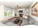Comfortable living room with a fireplace, built-in bookshelves, and a large picture window at 693 Prince Dr, Greenwood, IN 46142