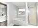 Bright main bathroom featuring a jacuzzi tub, separate shower, and view of the outside at 693 Prince Dr, Greenwood, IN 46142