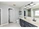 Brightly lit main bathroom with double sink vanity, large mirror, and tiled floors at 693 Prince Dr, Greenwood, IN 46142