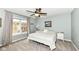 Light filled carpeted main bedroom with ceiling fan, serene paint color, and large window at 693 Prince Dr, Greenwood, IN 46142