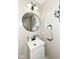 Well-lit powder room with white vanity, modern fixtures, decorative mirror, and neutral paint at 693 Prince Dr, Greenwood, IN 46142