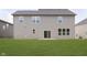 A large backyard with healthy, green grass and a gray two-story house at 7215 Barrett Dr, Brownsburg, IN 46112