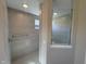 Modern tiled shower with glass door and brushed metal shower head in a clean, modern bathroom at 7215 Barrett Dr, Brownsburg, IN 46112