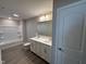 Bathroom with double sinks, a bathtub, and modern fixtures at 7215 Barrett Dr, Brownsburg, IN 46112