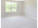 A bright bedroom featuring a window with natural light and soft carpeting, perfect for relaxation at 7215 Barrett Dr, Brownsburg, IN 46112