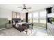 A bedroom has green walls, a desk, three large windows, and a modern ceiling fan at 7215 Barrett Dr, Brownsburg, IN 46112